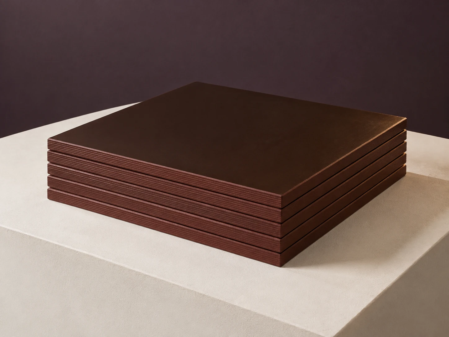 Stack of film-faced formwork plywood with smooth dark brown phenolic film faces and sealed edges